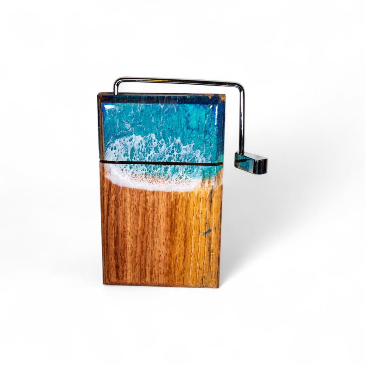 Front view of handcrafted wood and resin ocean wave cheese slicer with metal lever