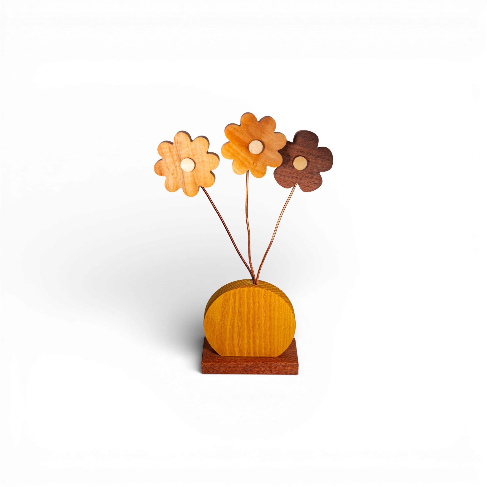 Front view of handmade wooden daisy flowers with amber and brown wood tones