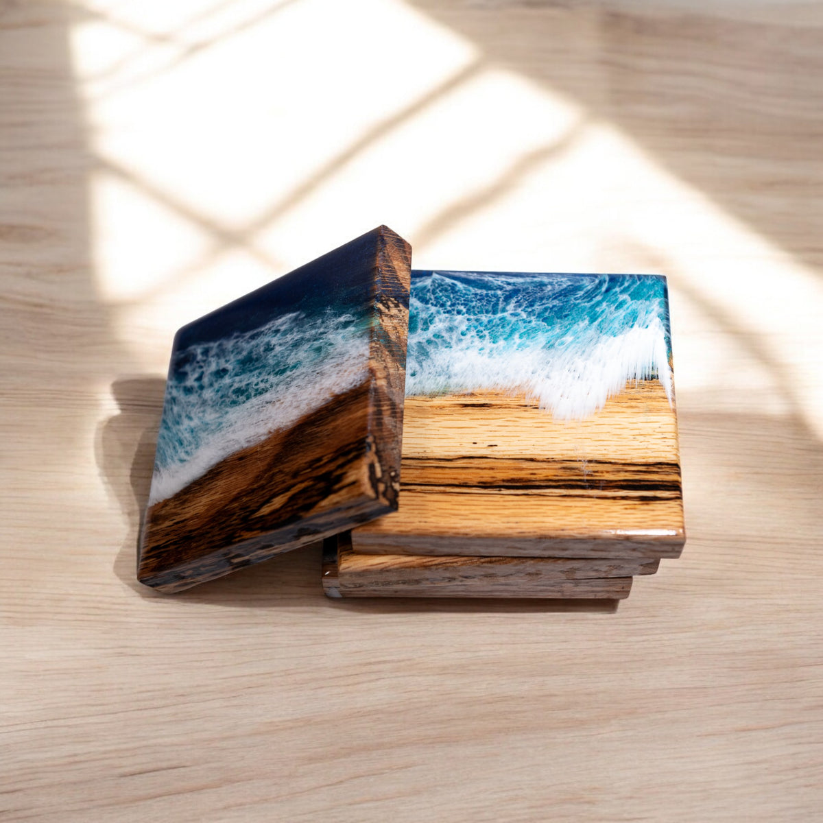 Stacked 4x4 inch Maple and epoxy coasters showing side profile thickness
