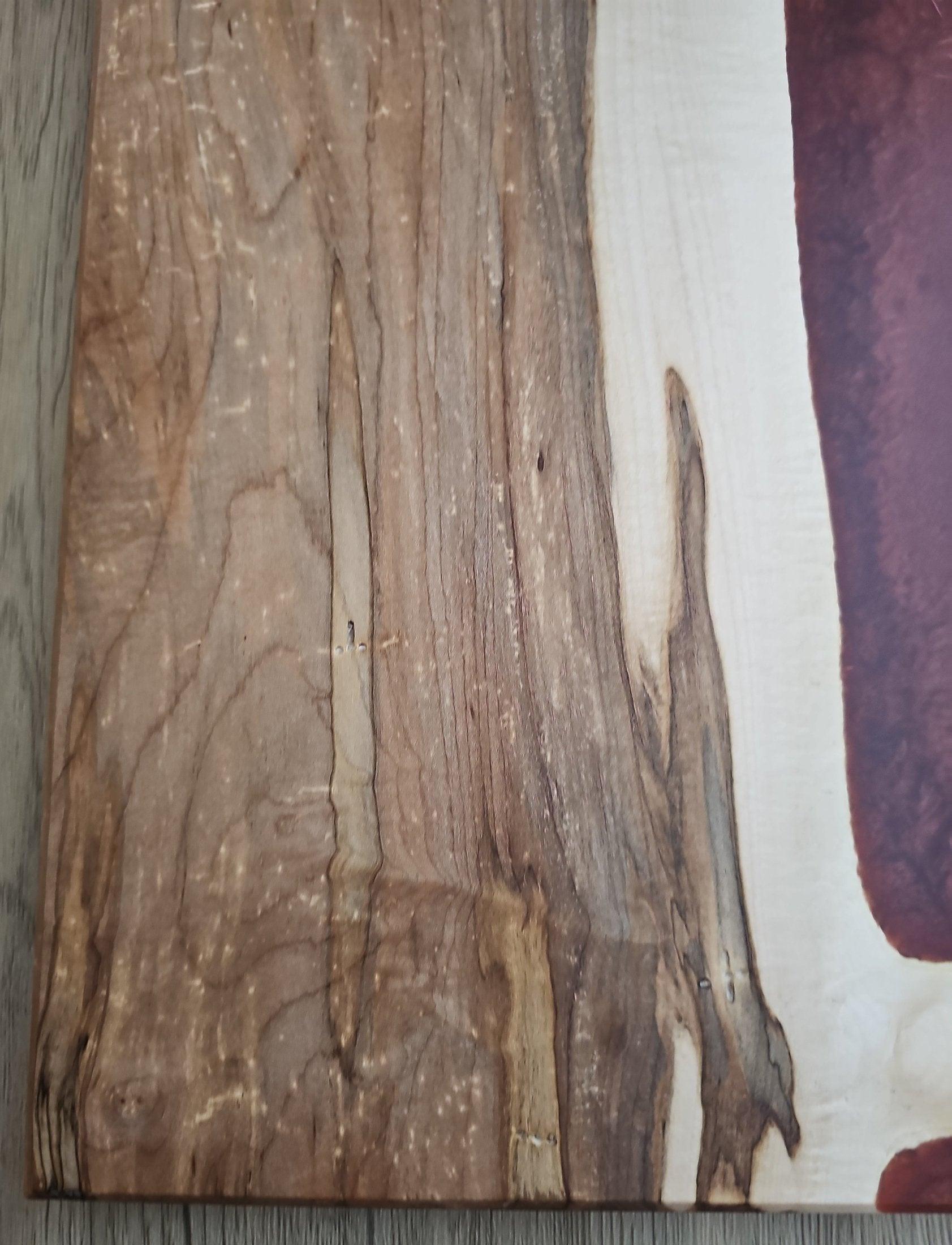 Live edge maple charcuterie board with copper epoxy inlay detail