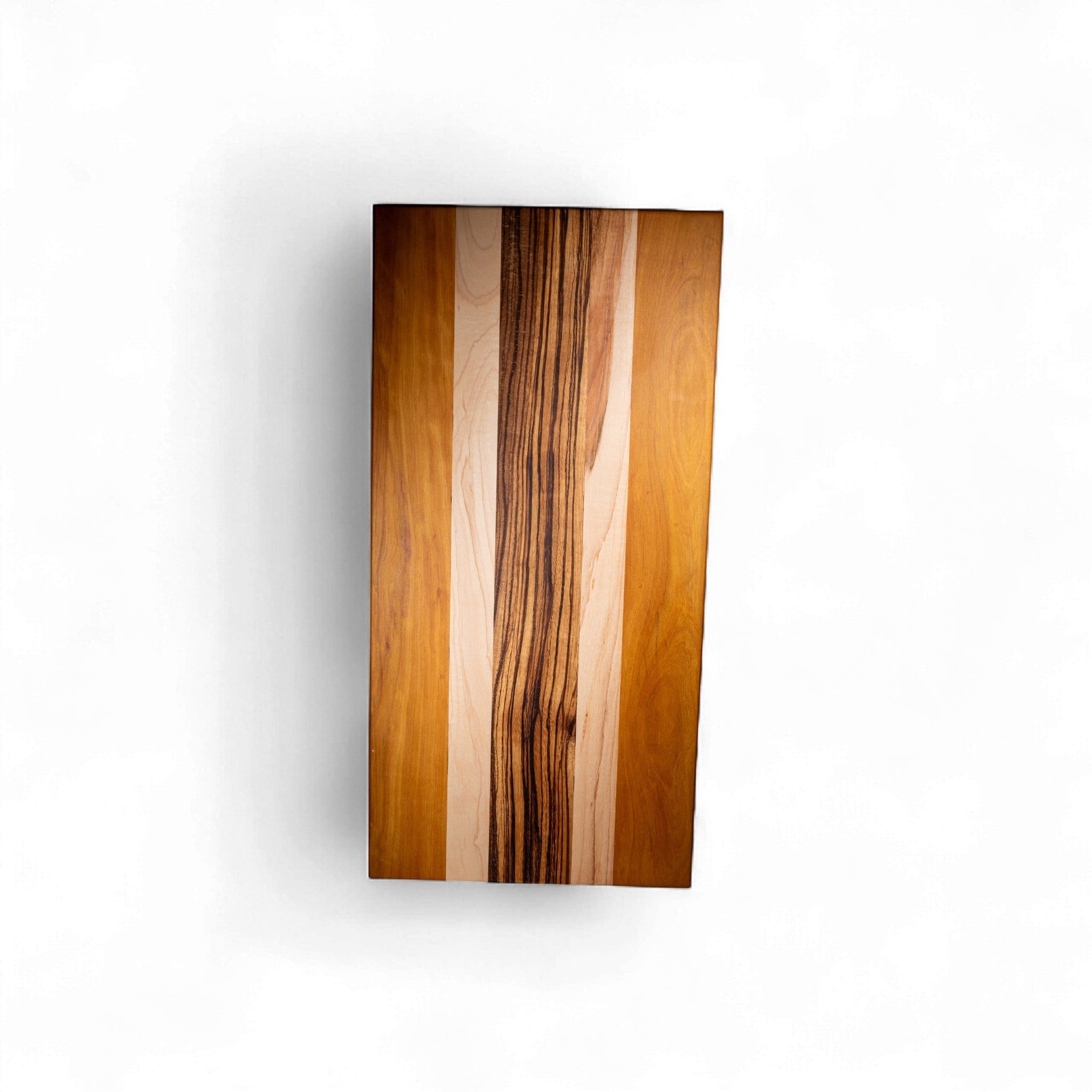 Food-safe wooden cutting board with dark zebra wood streaks and light beige grain