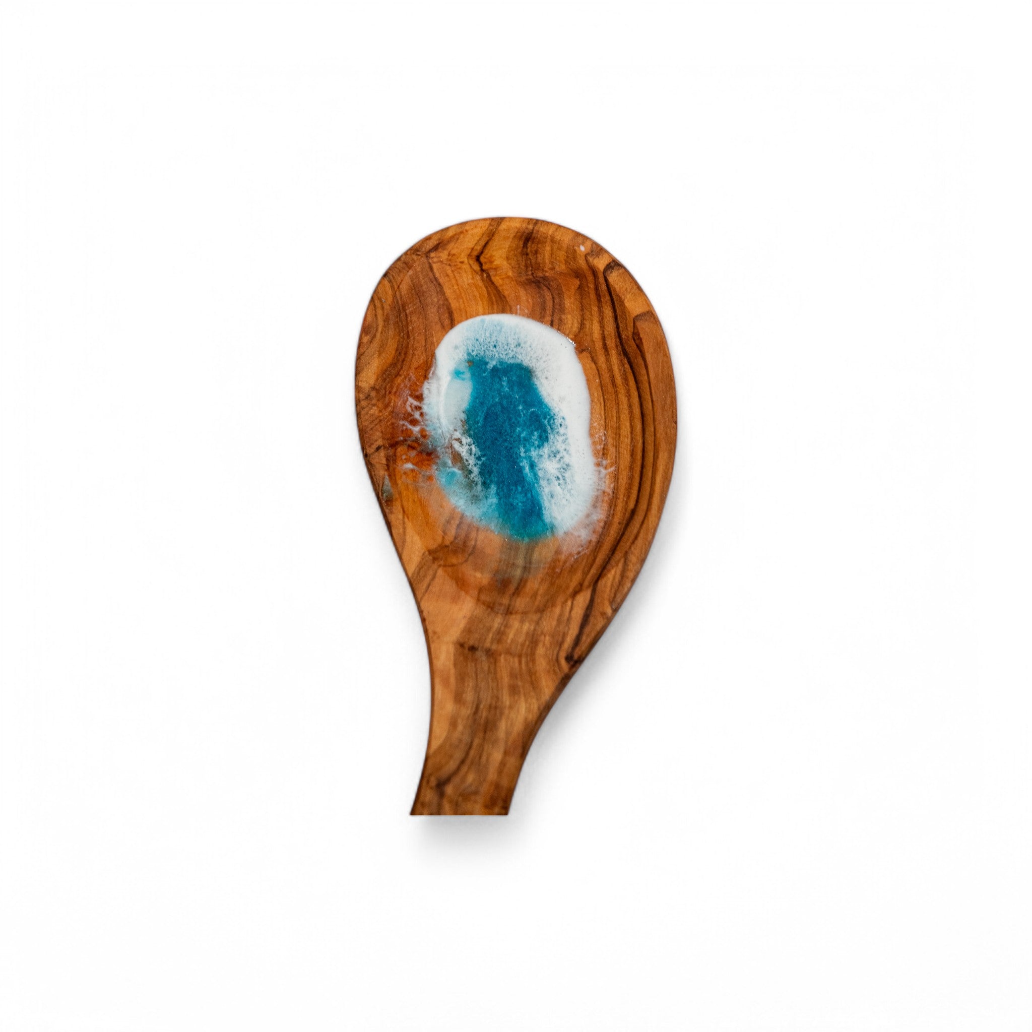 Front view of organic olive wood spoon rest with deep blue resin ocean wave design and frothy white crest