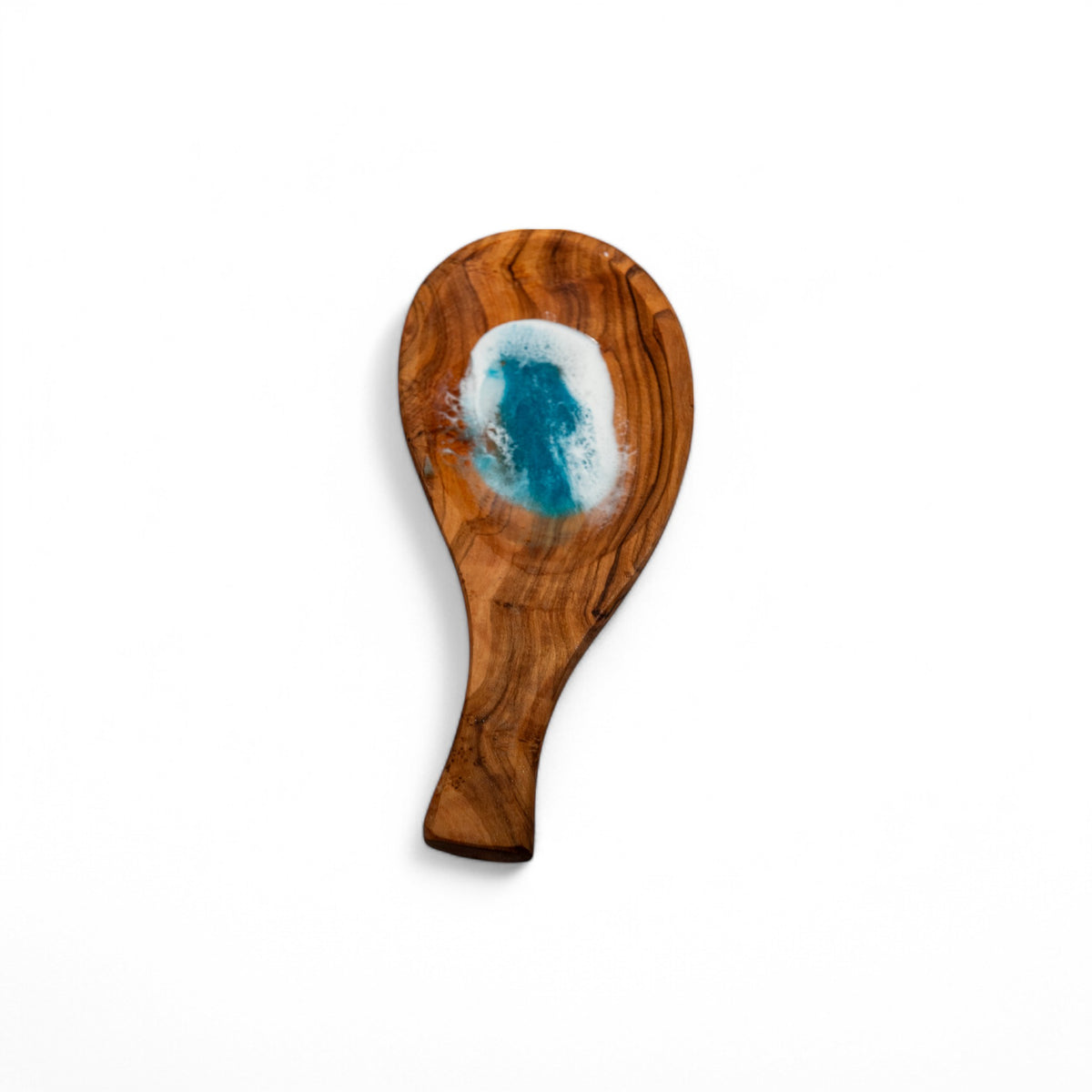 Side profile of ergonomic olive wood spoon rest showing natural grain variations and concave resin wave bowl