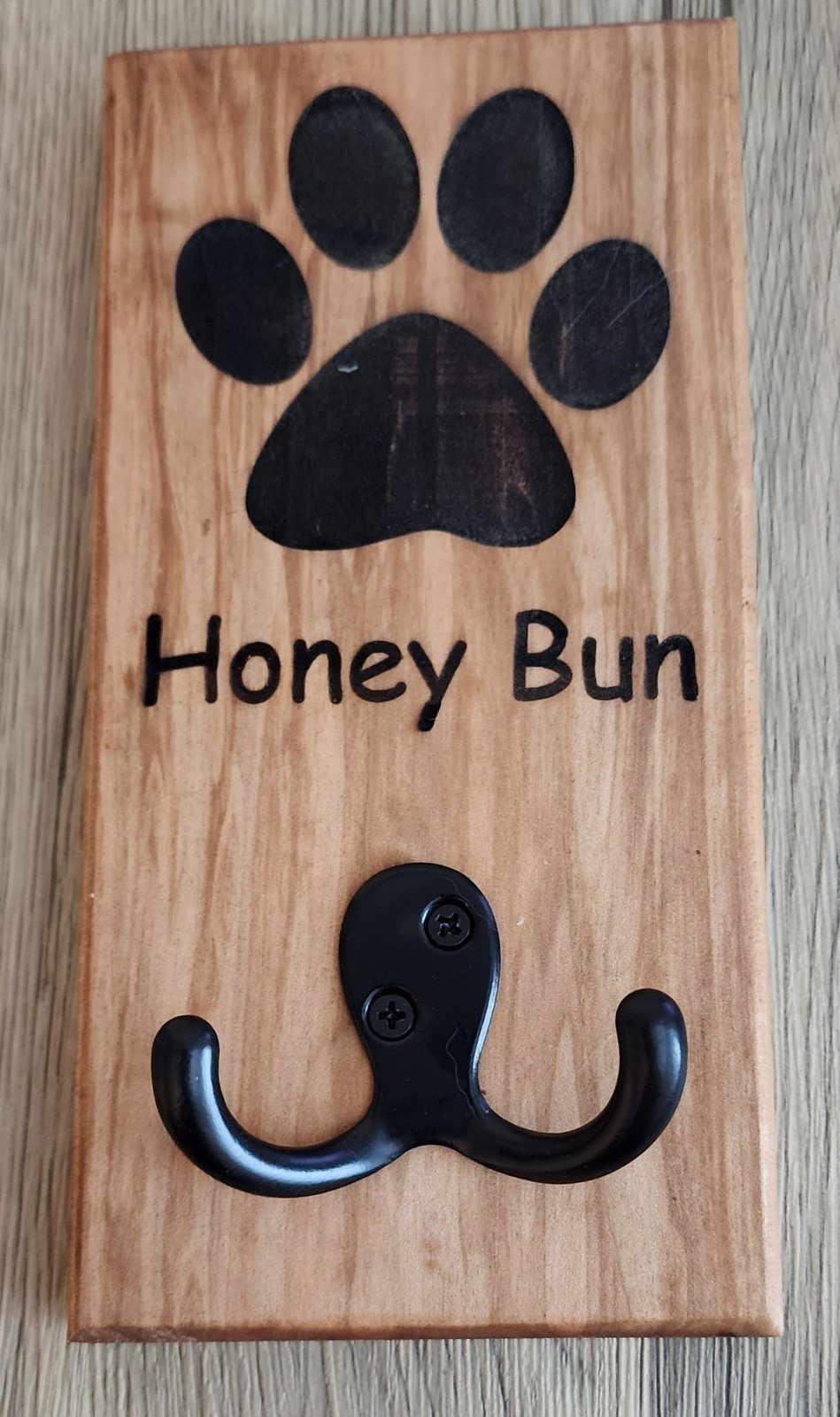 Personalized wooden dog leash holder engraved with 'Honey Bun' and double hook