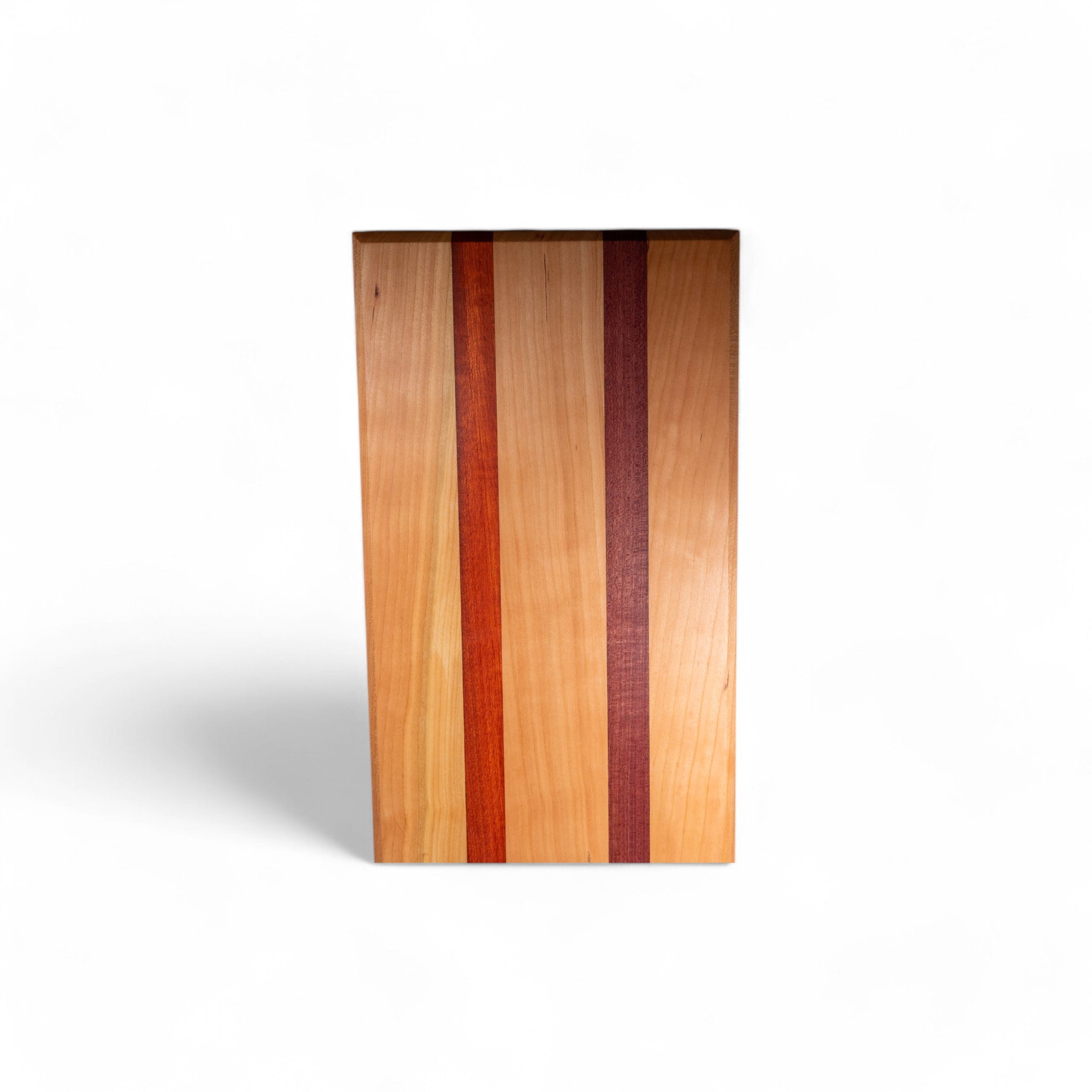 Rectangular cherry cutting board featuring padauk and purpleheart inlay strips