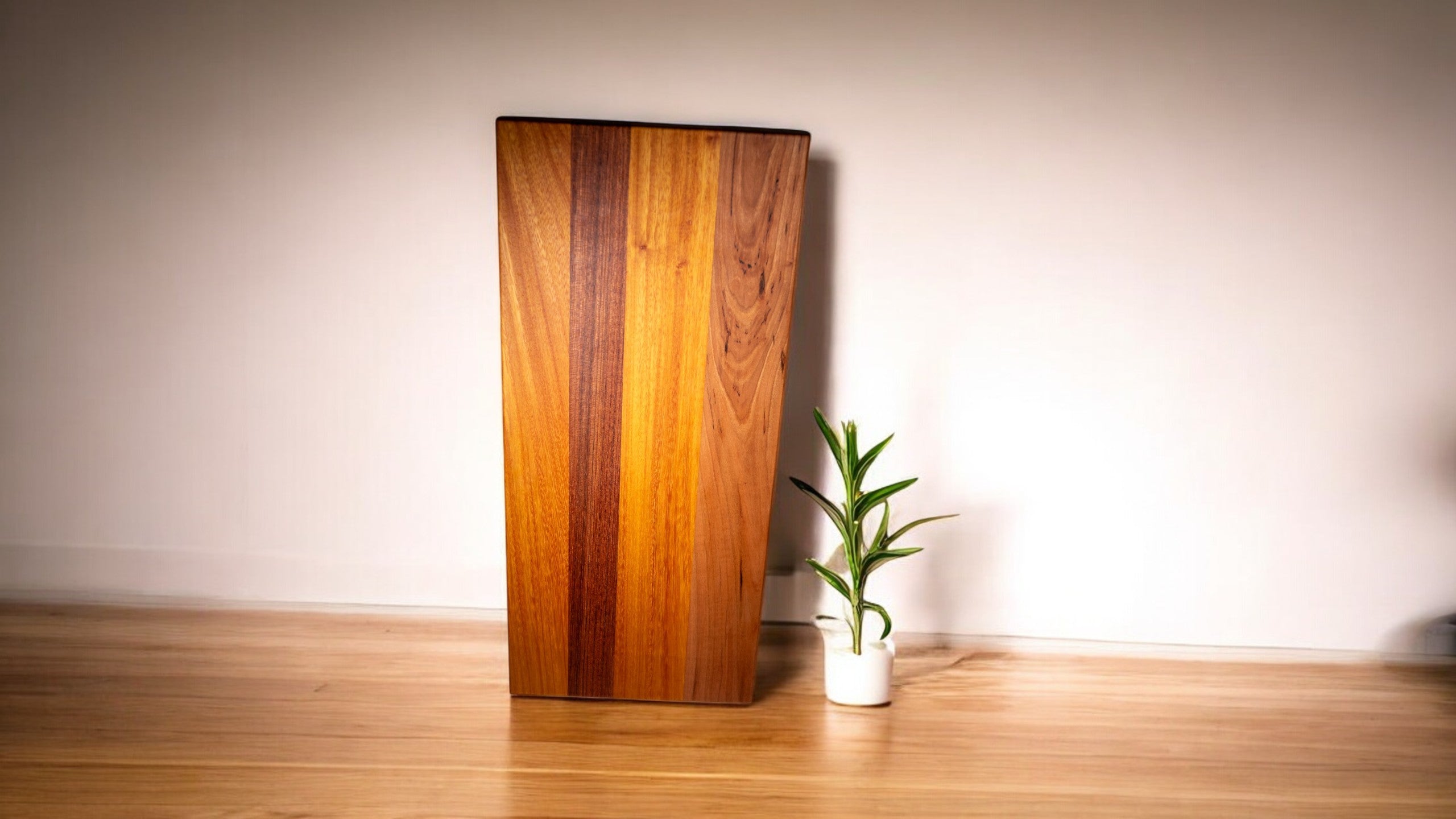 Wood Charcuterie Board with plant sitting next to it. 