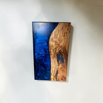 Handmade dark blue epoxy and maple wood serving board with marbled texture