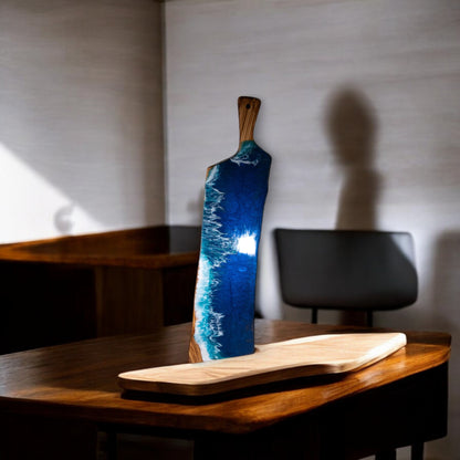 Vertical ocean wave resin charcuterie board displayed on wooden table