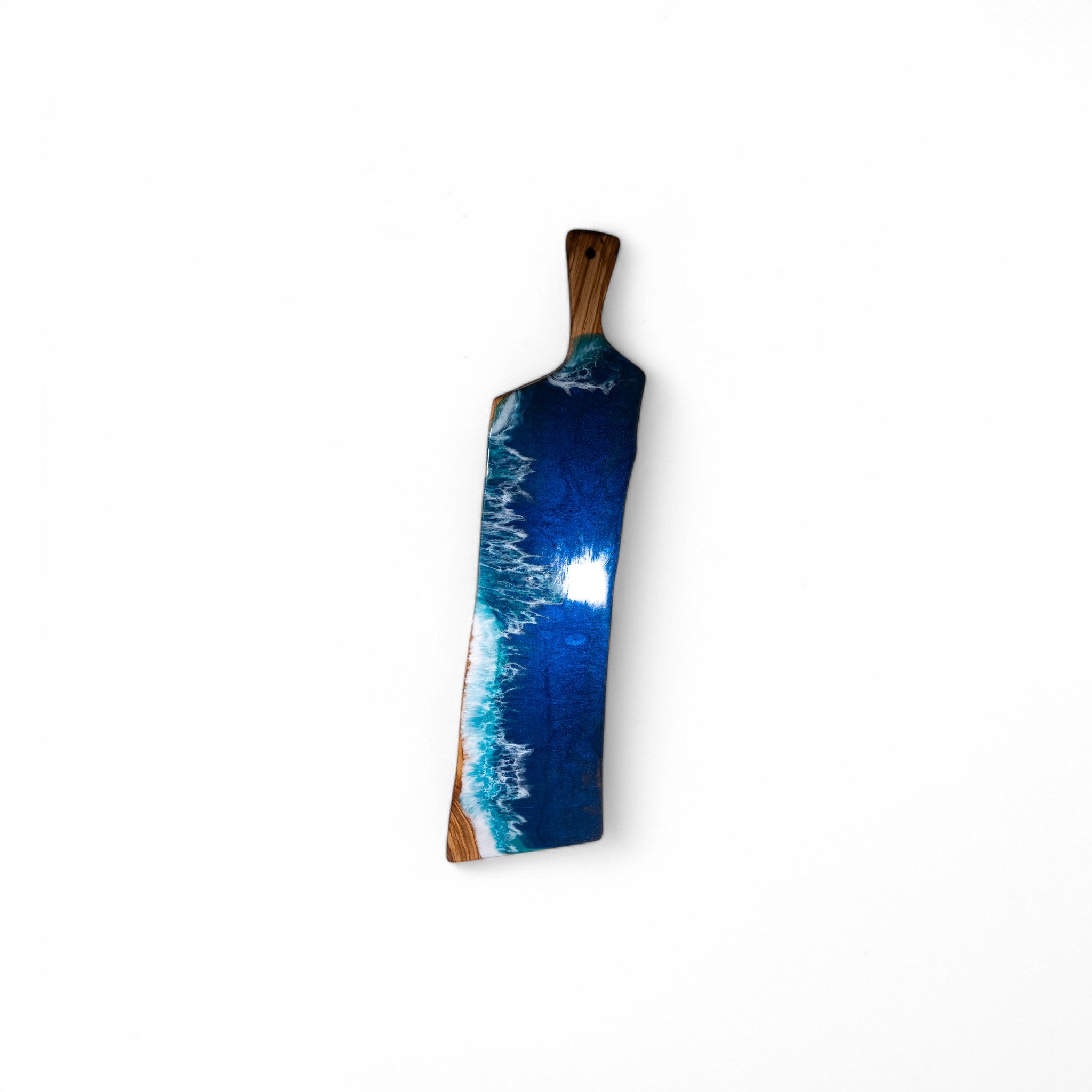 Custom resin ocean wave olive wood cutting board showing food-safe finish
