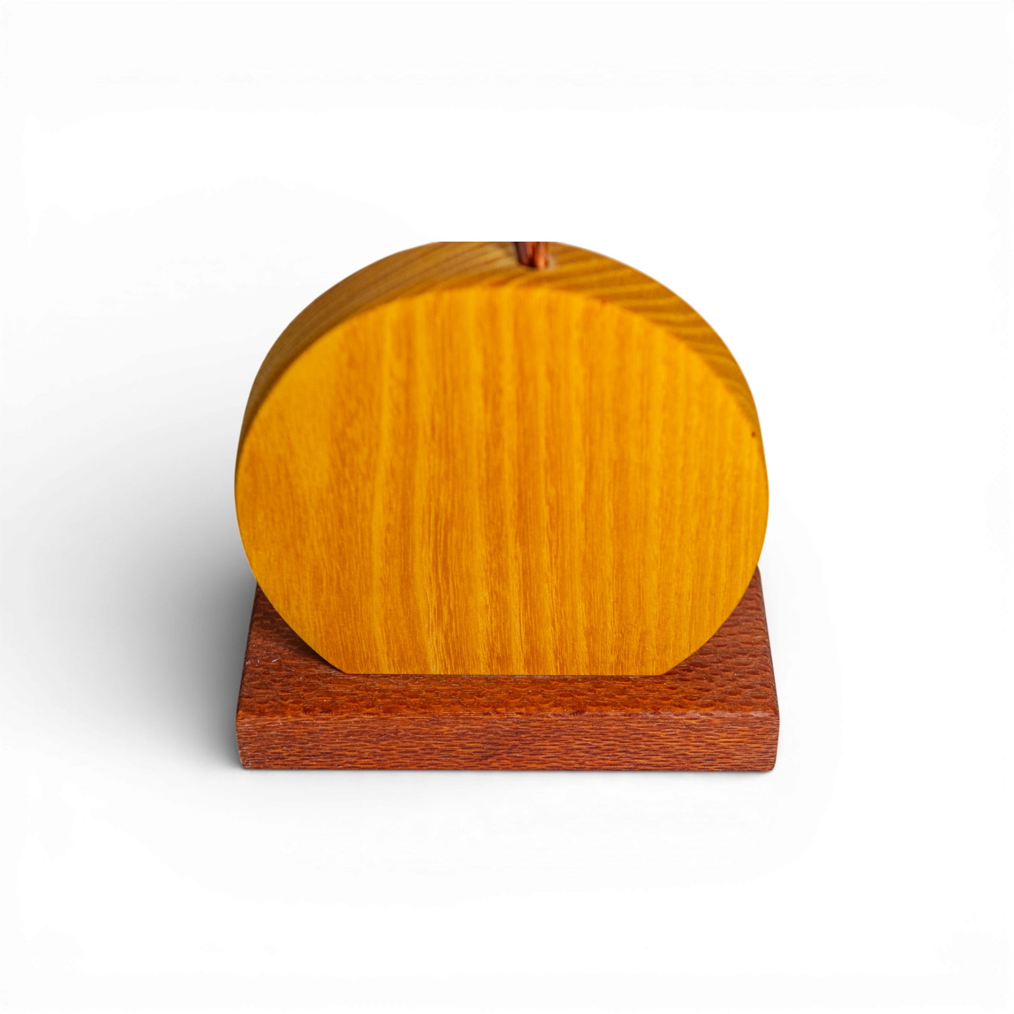 Detail shot of yellow wooden disc base with vertical grain and reddish-brown stand