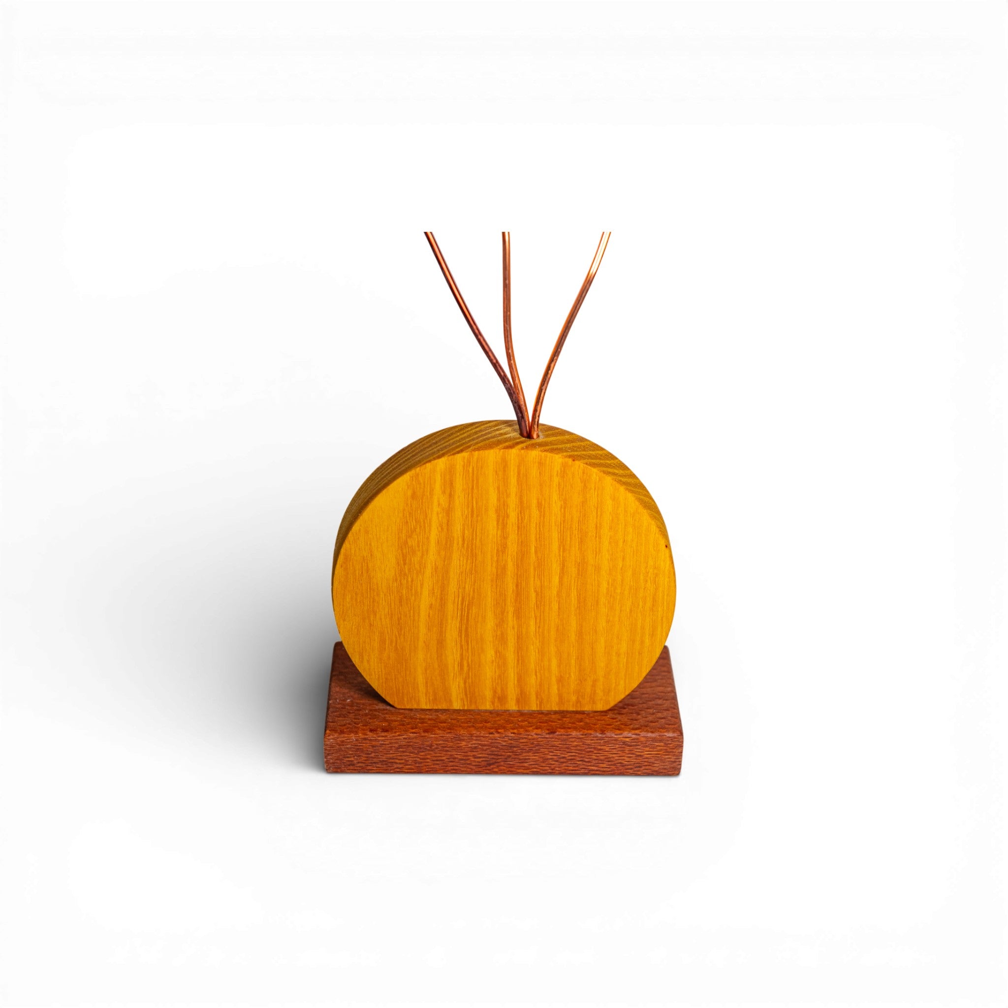 Yellow wooden base and dark stand for handmade daisy flower arrangement with copper stems