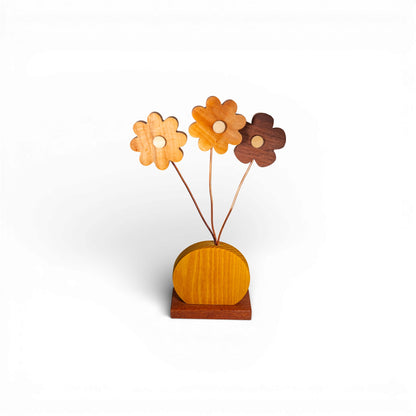 Three-tone wooden daisy flower arrangement with varied grain patterns and copper stems