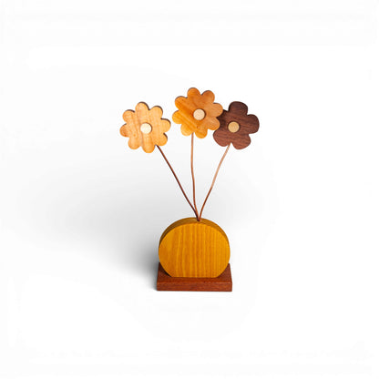 Front view of handmade wooden daisy flowers with amber and brown wood tones