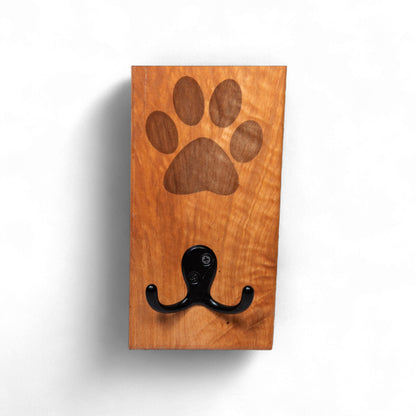 Front view of handcrafted cherry wood dog leash holder with engraved paw print