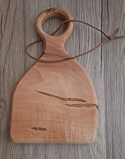 Maple charcuterie board with walnut wood grain and leather handle strap