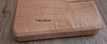 Close-up of natural maple wood grain texture on serving tray surface