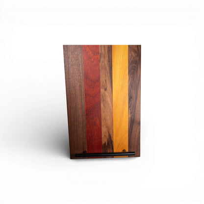 Striped charcuterie board combining walnut padauk osage wood with bottom mounted handle