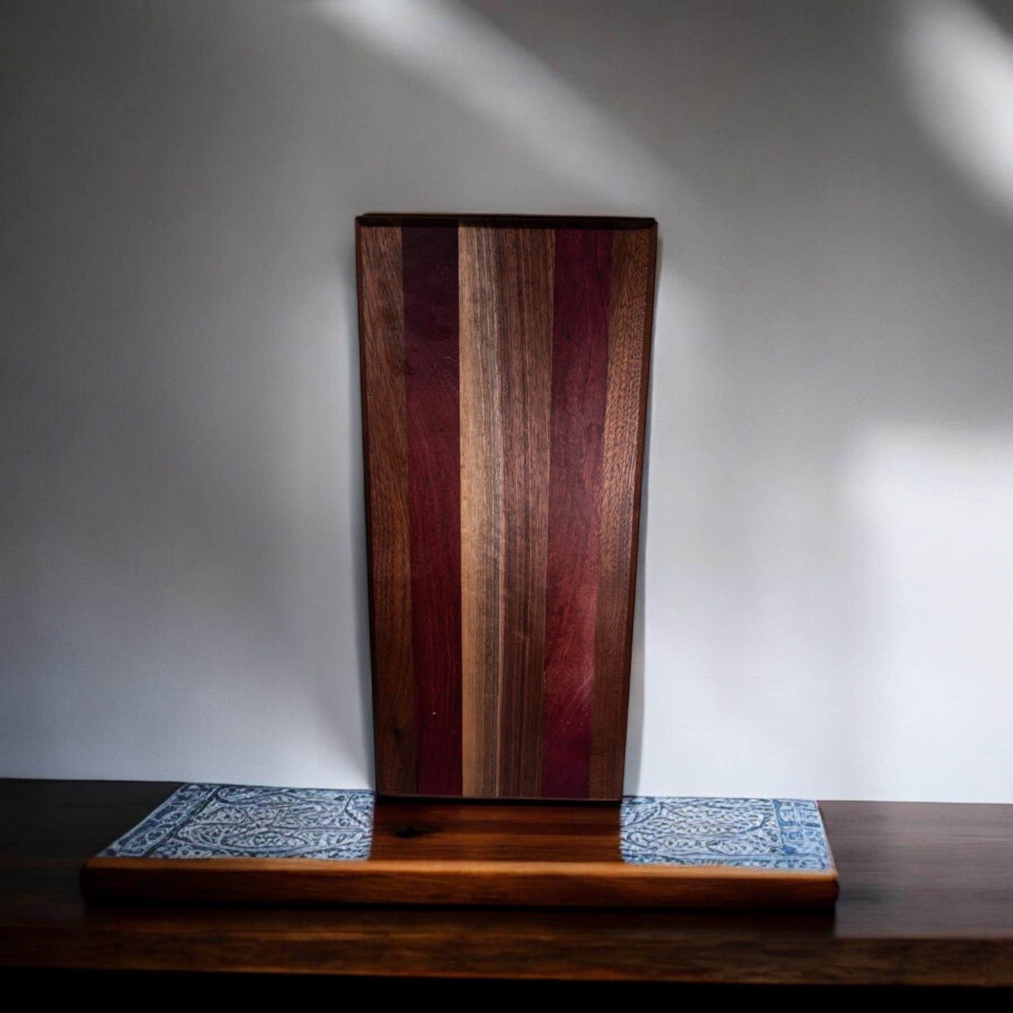 Walnut and purple heart charcuterie board on wooden stand display
