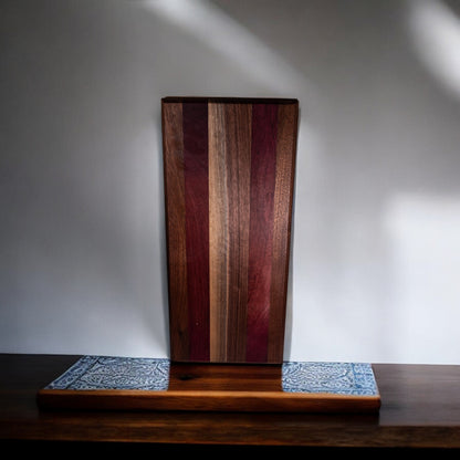 Walnut and purple heart charcuterie board on wooden stand display