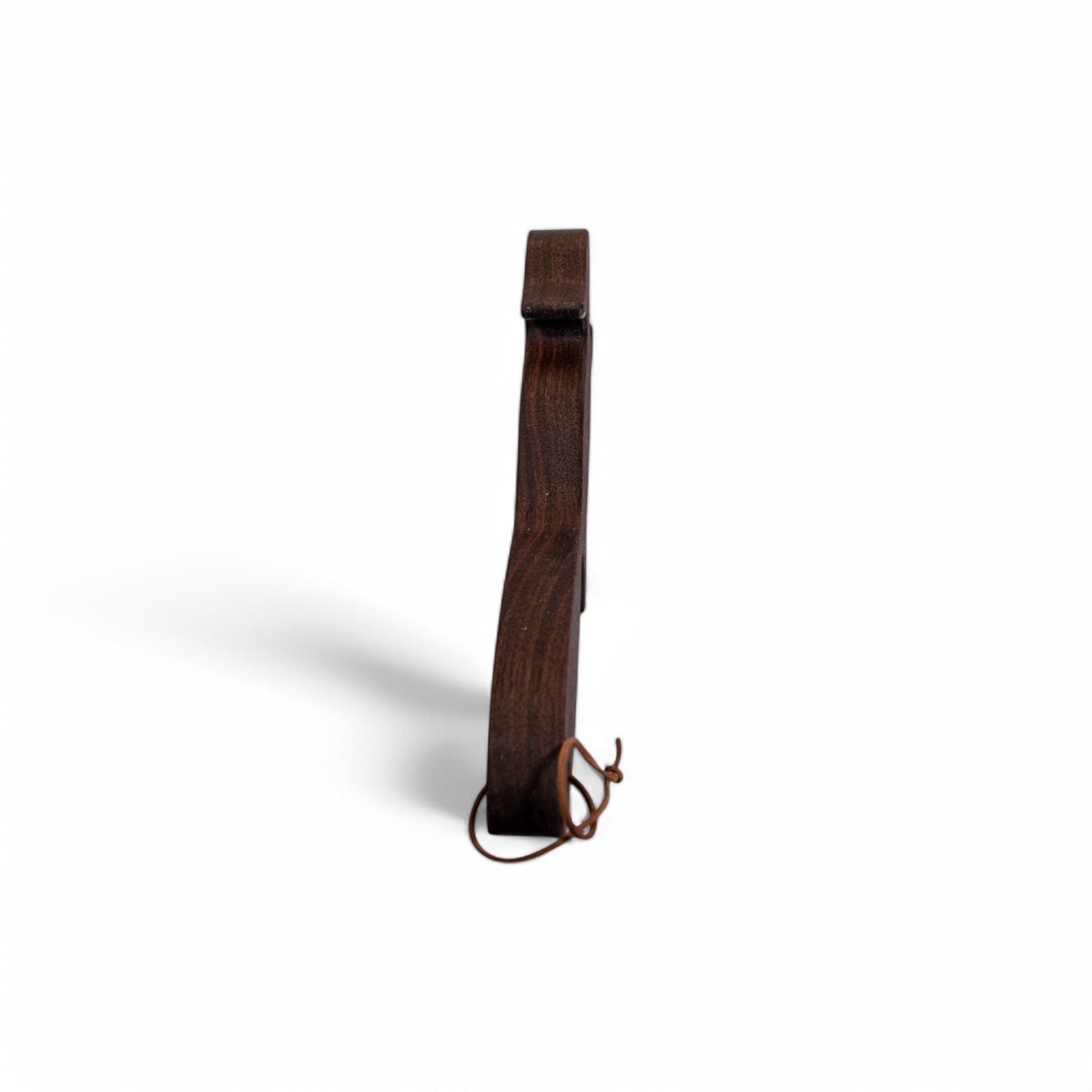 Side profile of dark walnut squirrel oven rack puller showing thickness