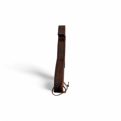 Side profile of dark walnut squirrel oven rack puller showing thickness