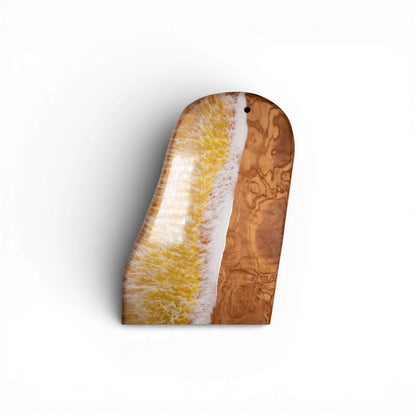Yellow resin ocean wave olive wood serving platter with hanging hole detail