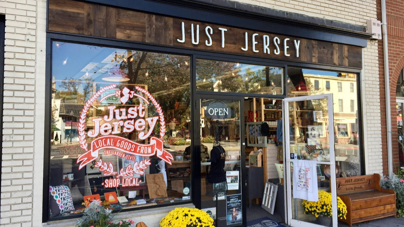 Storefront of 'Just Jersey' with large glass windows and outdoor seating area.